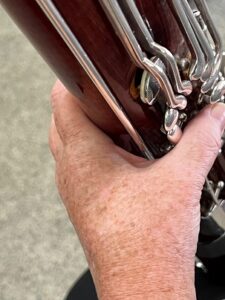 base of left index finger provides support and balance