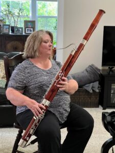 Dr. Lowe holding the bassoon in playing position w good posture
