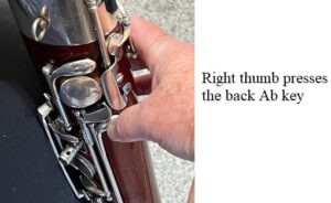 right thumb pressed the back a-flat key