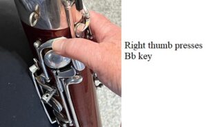 right thumb pressing the Bb key